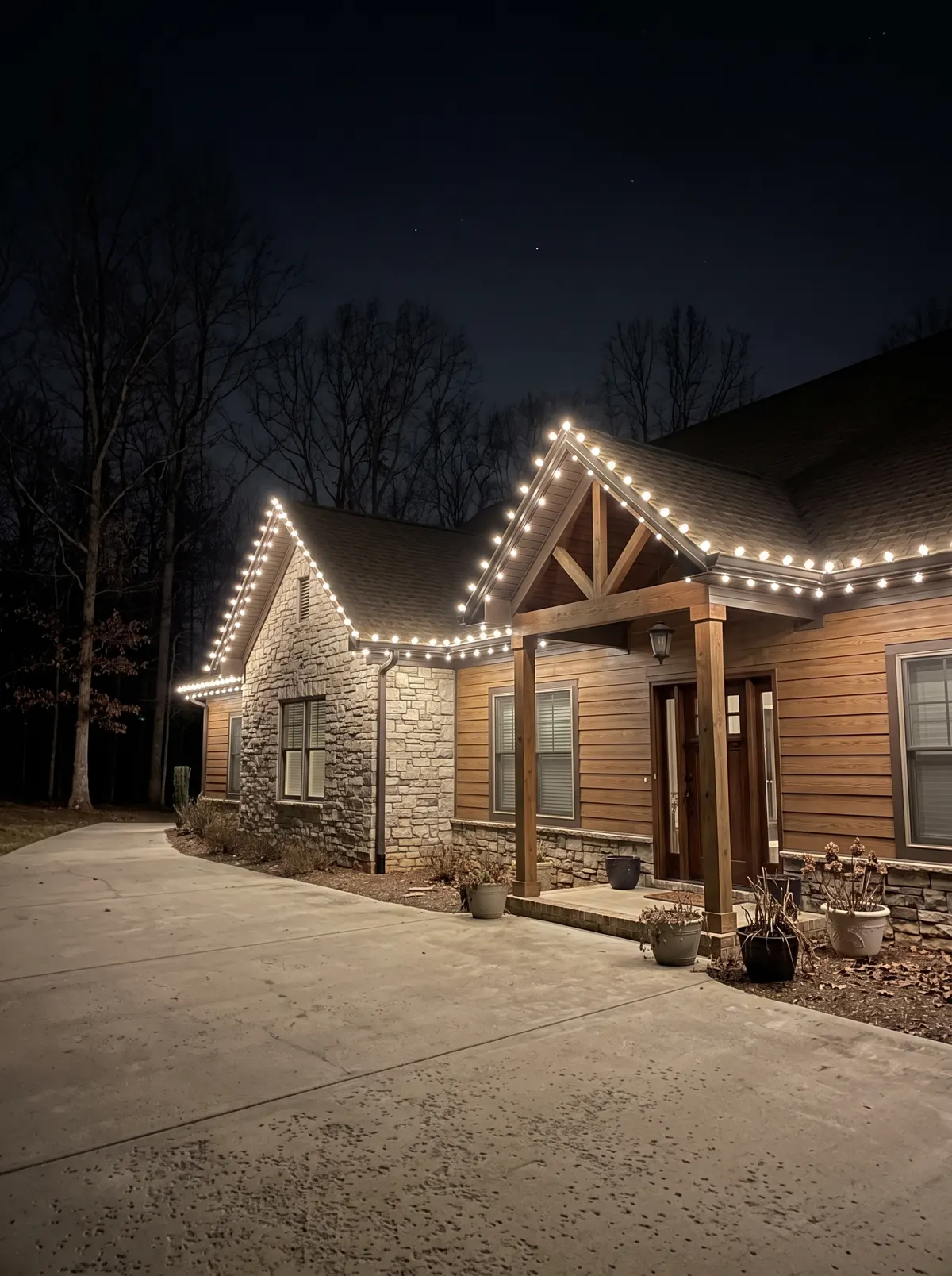 Stone and cedar home with warm-white C9 on the gable rakes and eaves