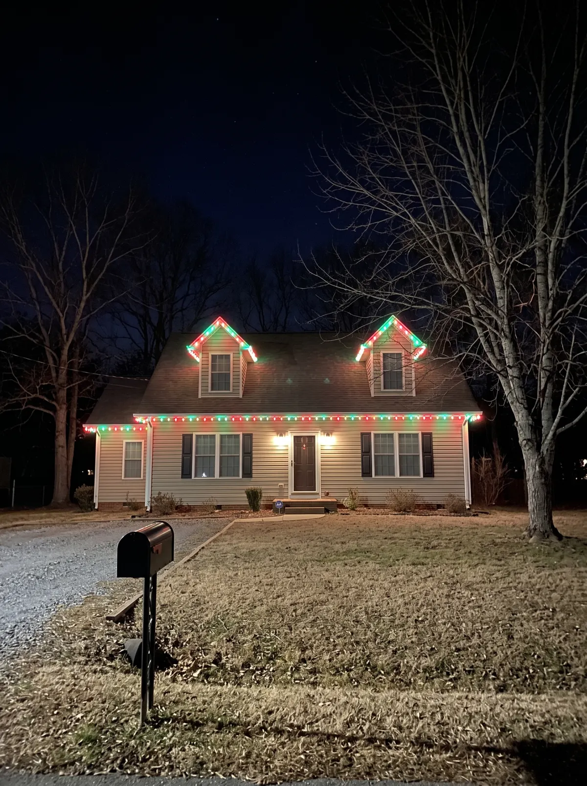 Cape cod with red and green C9 on the dormers and eave line