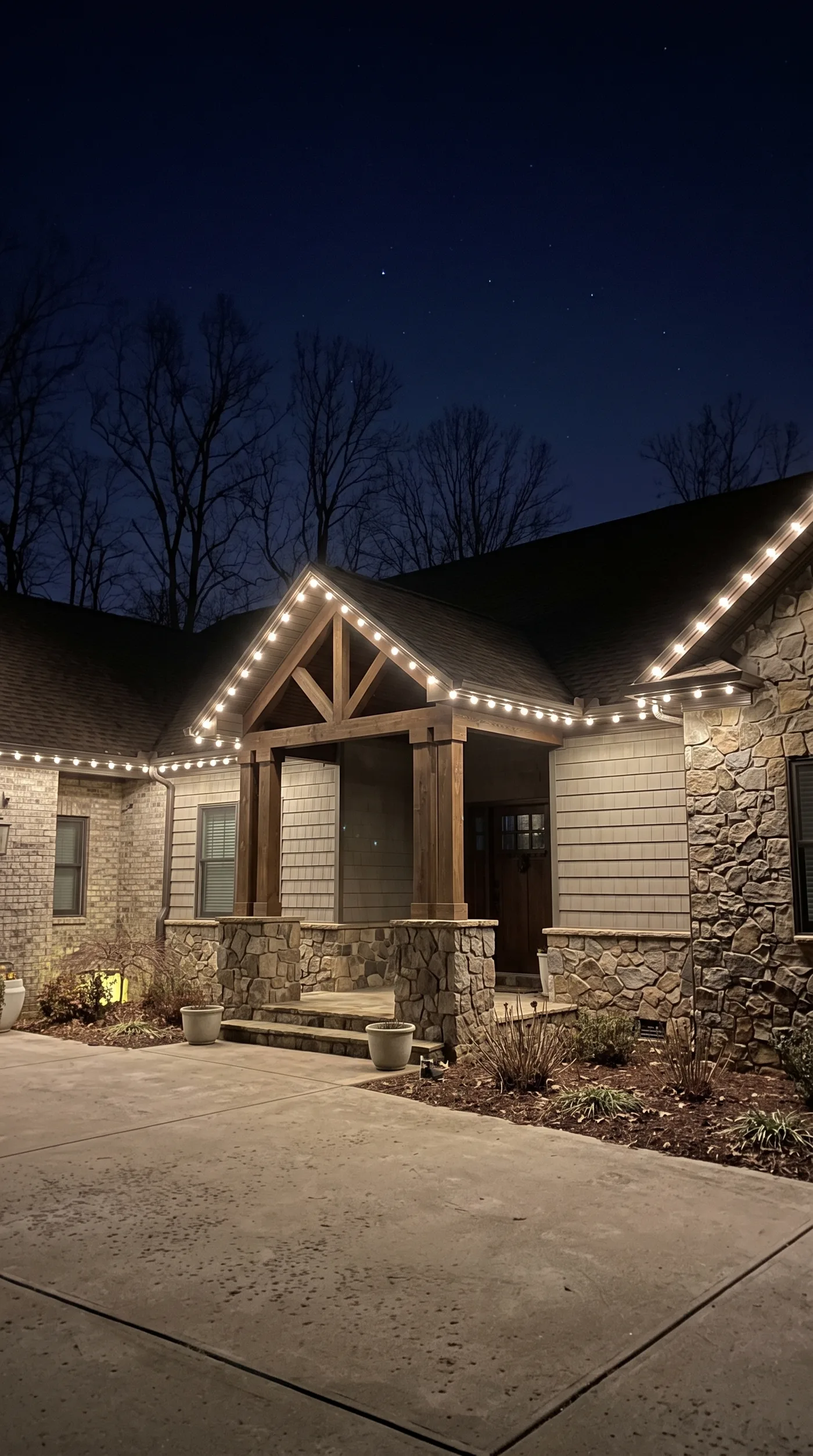 Warm-white bulbs tracing a timber-frame gable entry