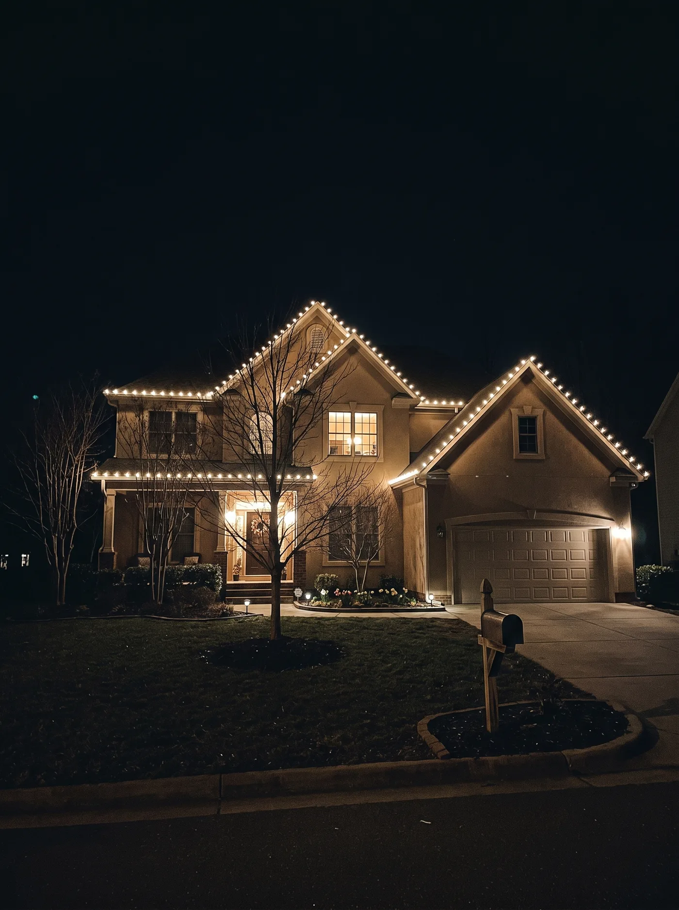 Two-story home with warm-white C9 lighting along every roofline